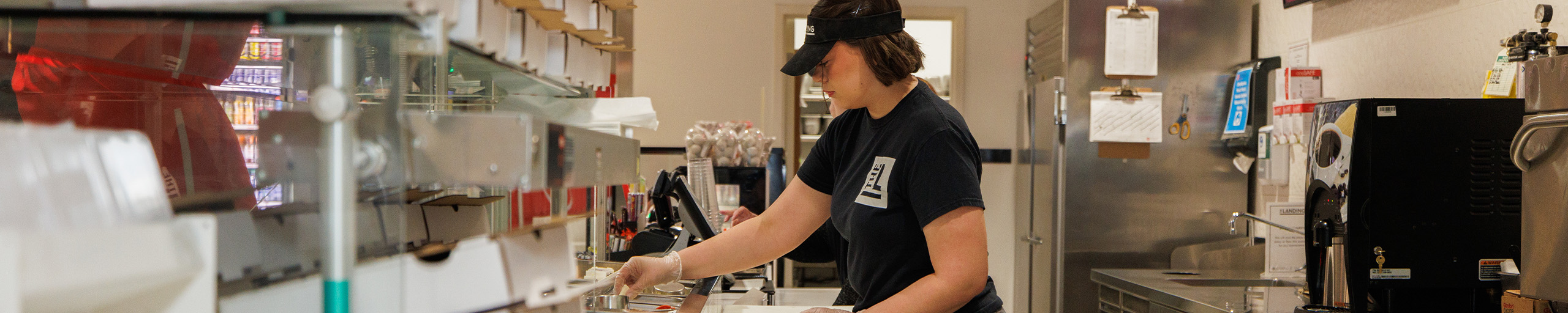 EMDH employee wipes down tables.